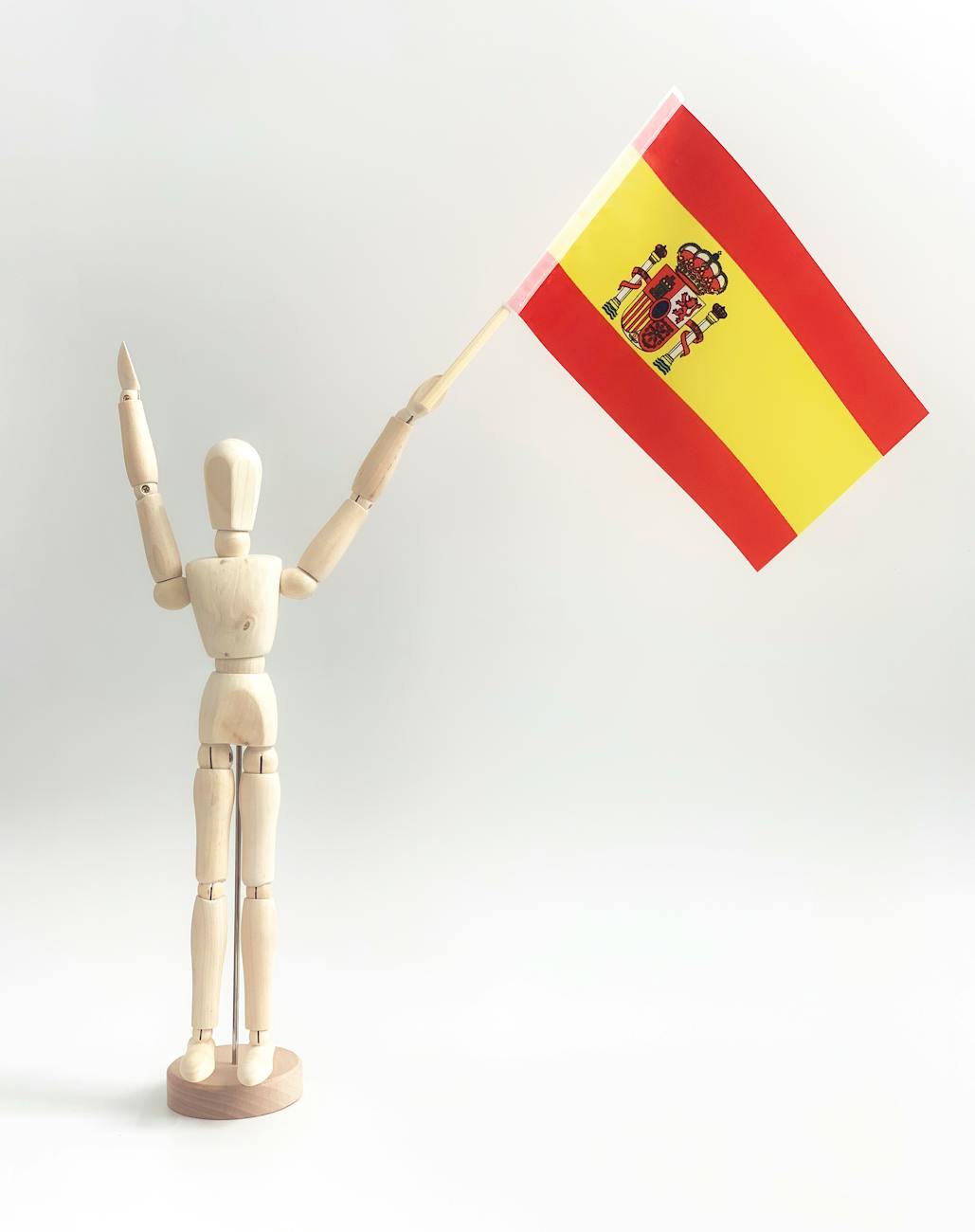 close up shot of a wooden figurine holding a flag