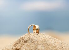 gold wedding bands on sand